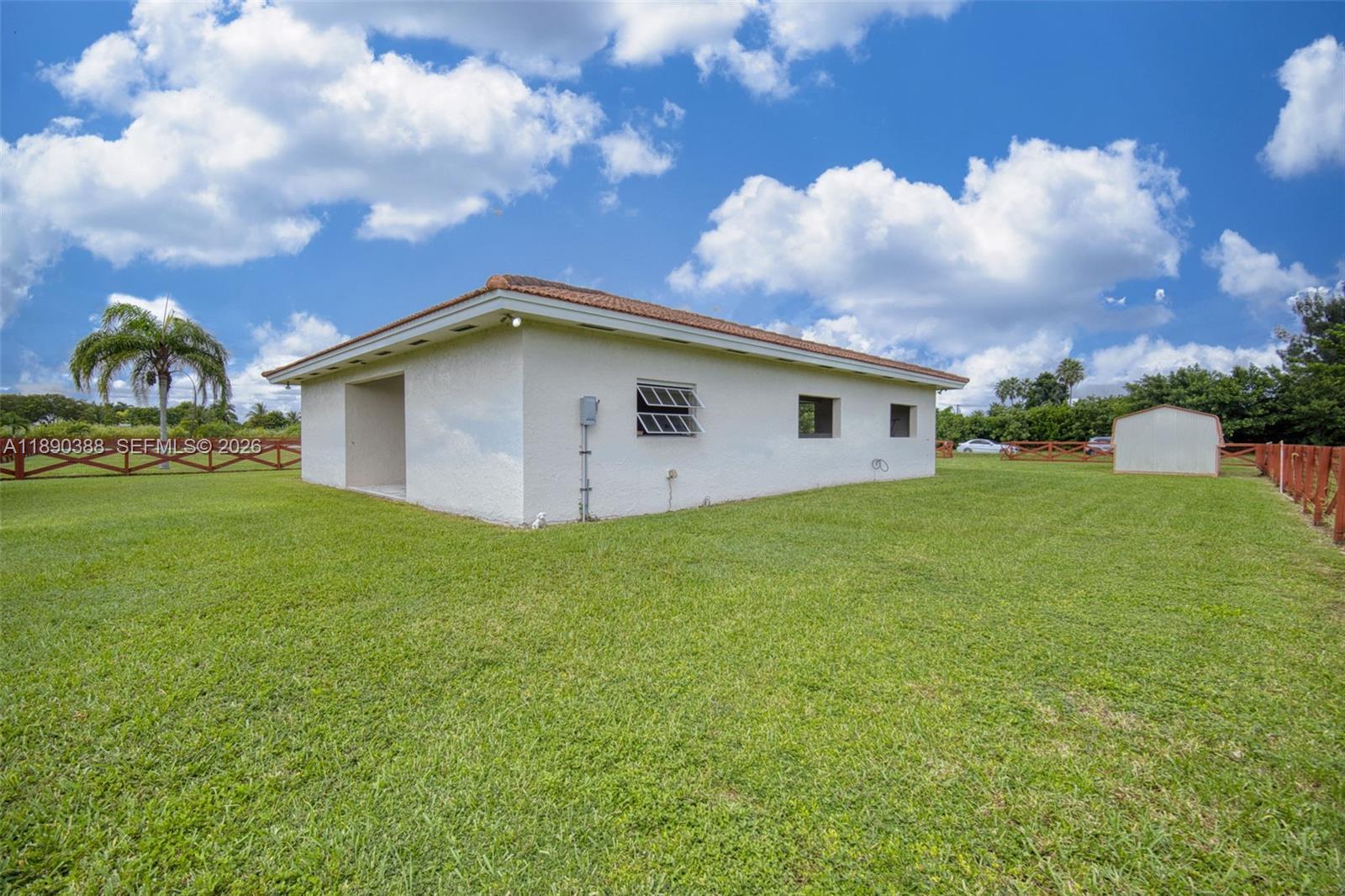 27743 Southwest 172nd Place Homestead, FL 33031 - Photo 25 of 35 a blue house with a yard