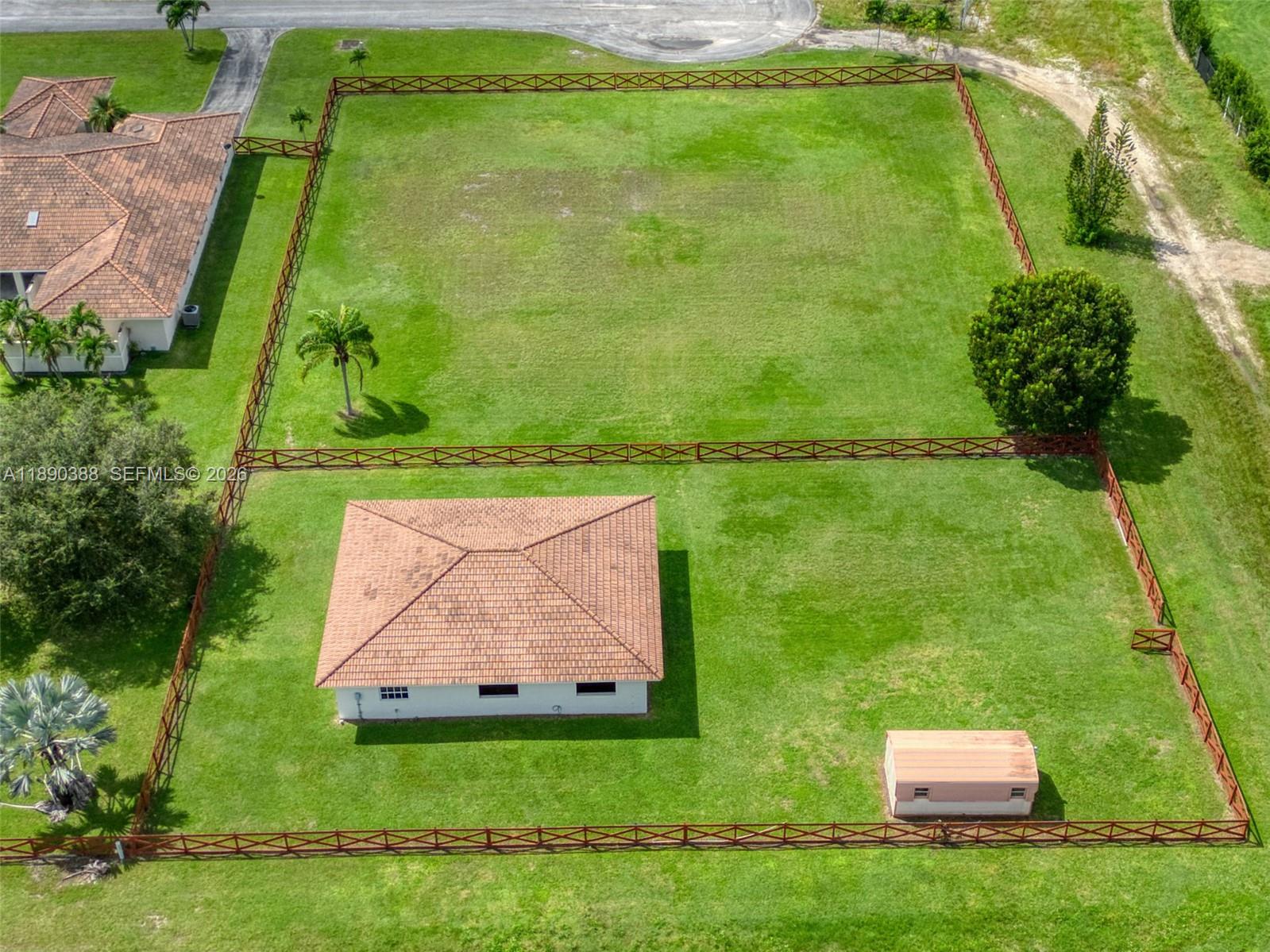 27743 Southwest 172nd Place Homestead, FL 33031 - Photo 3 of 35 a backyard of a house with lots of green space and plants