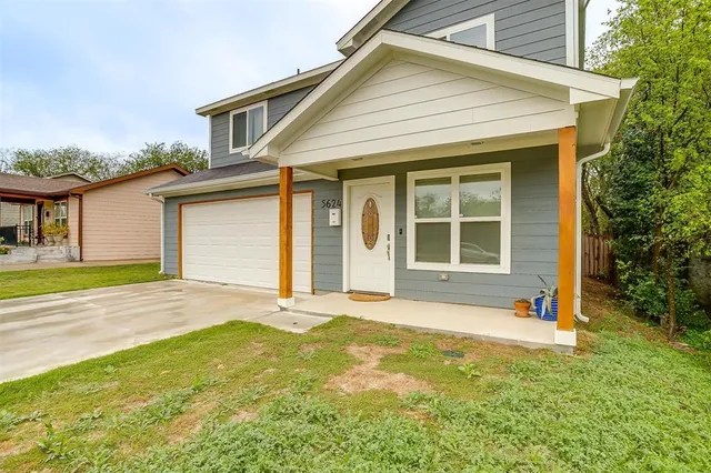 a view of a house with a garden and yard