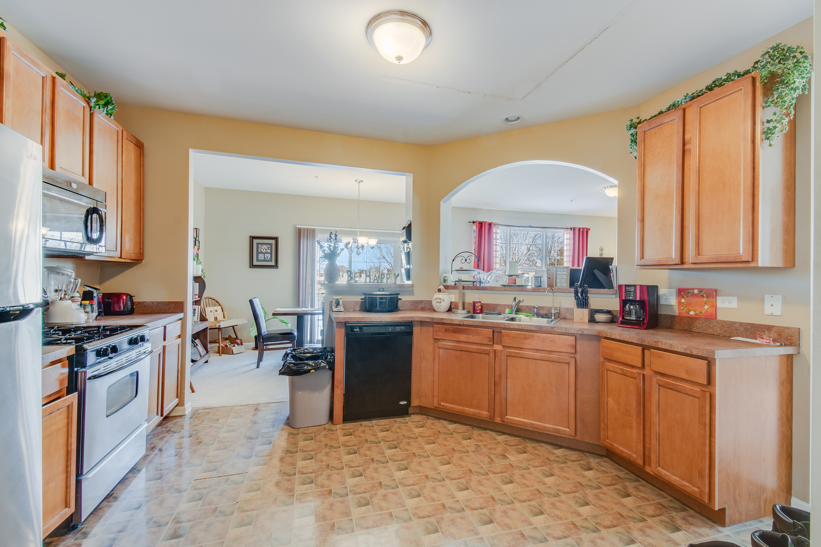 2765 Crooker Drive Yorkville, IL 60560 - Photo 8 of 21 a kitchen with stainless steel appliances granite countertop a stove top oven a sink dishwasher a dining table and chairs with wooden floor