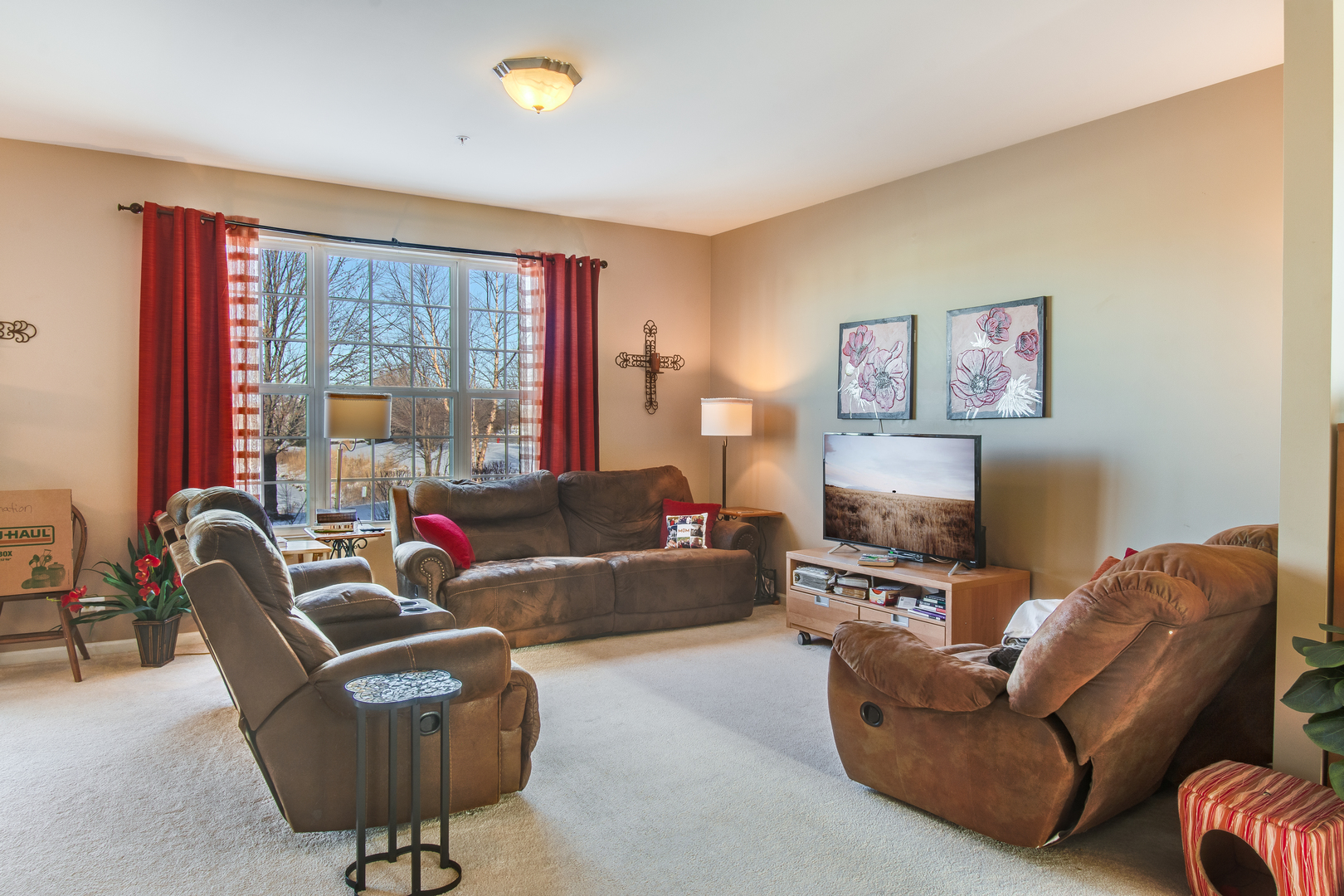 2765 Crooker Drive Yorkville, IL 60560 - Photo 9 of 21 a living room with furniture a large window and a flat screen tv