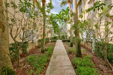 a view of a pathway with a wrought fence