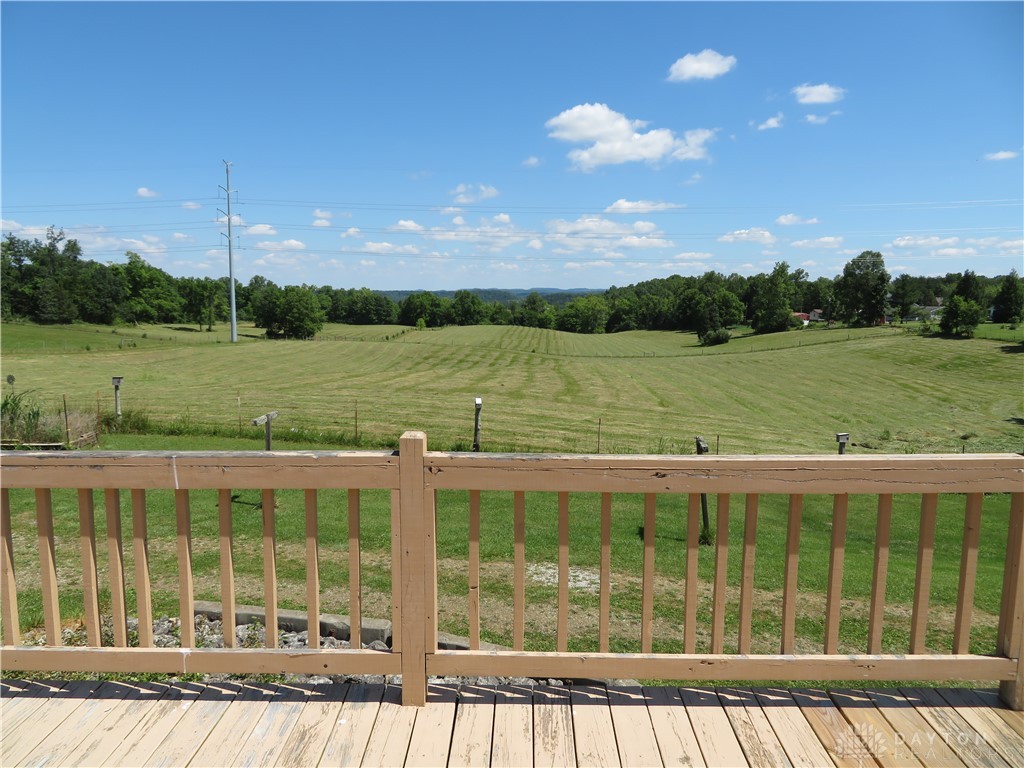 748 Inlow Avenue Peebles, OH 45660 - Photo 33 of 61 This outdoor deck offers expansive views of rolling hills and vibrant green fields.
