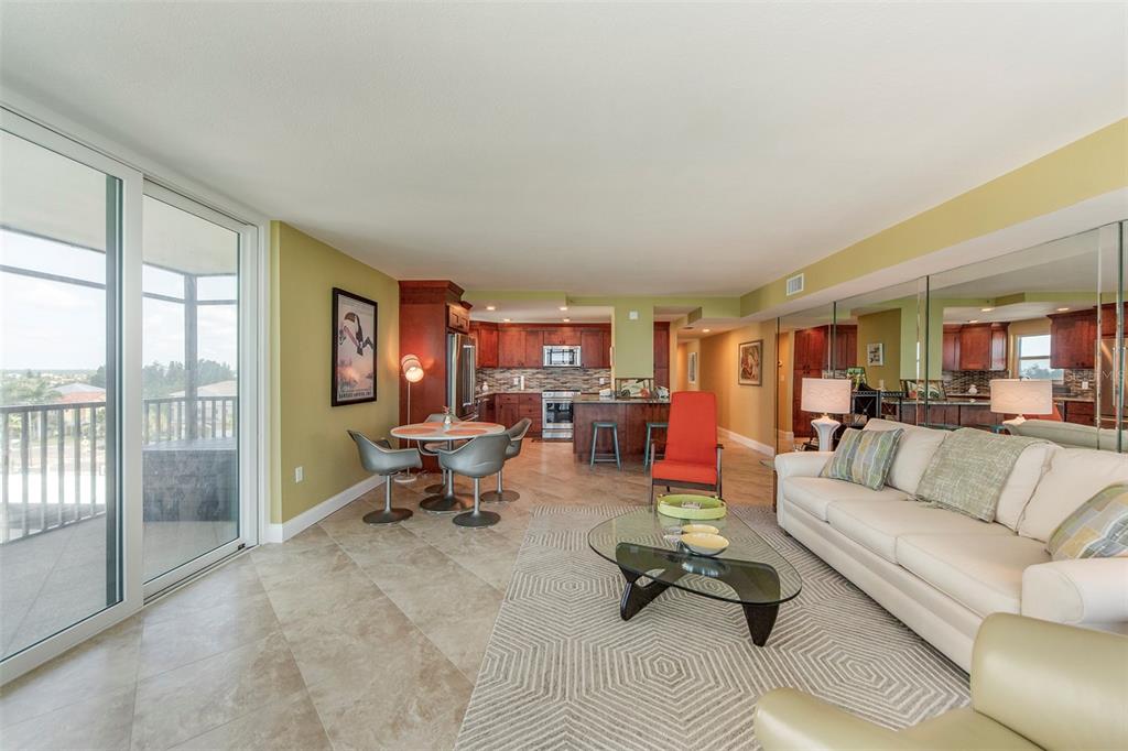 15400 Gulf Boulevard, Unit 505 Madeira Beach, FL 33708 - Photo 12 of 27 a living room with furniture and a floor to ceiling window