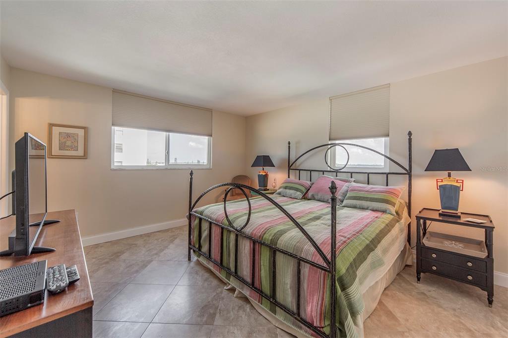 15400 Gulf Boulevard, Unit 505 Madeira Beach, FL 33708 - Photo 17 of 27 a bedroom with furniture and a window