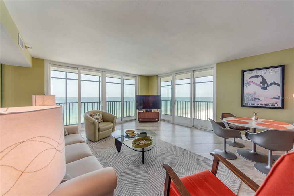 15400 Gulf Boulevard, Unit 505 Madeira Beach, FL 33708 - Photo 9 of 27 a living room with furniture and a large window