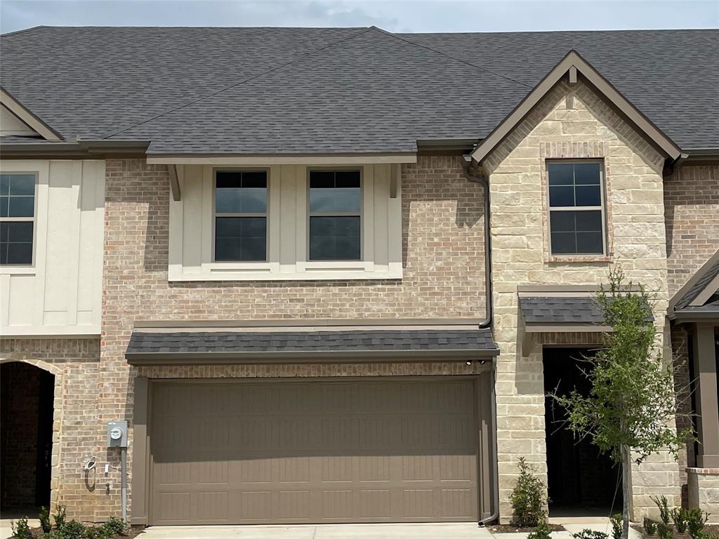 a front view of a house with garage