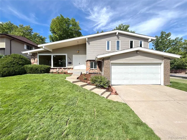 a front view of house with yard and green space
