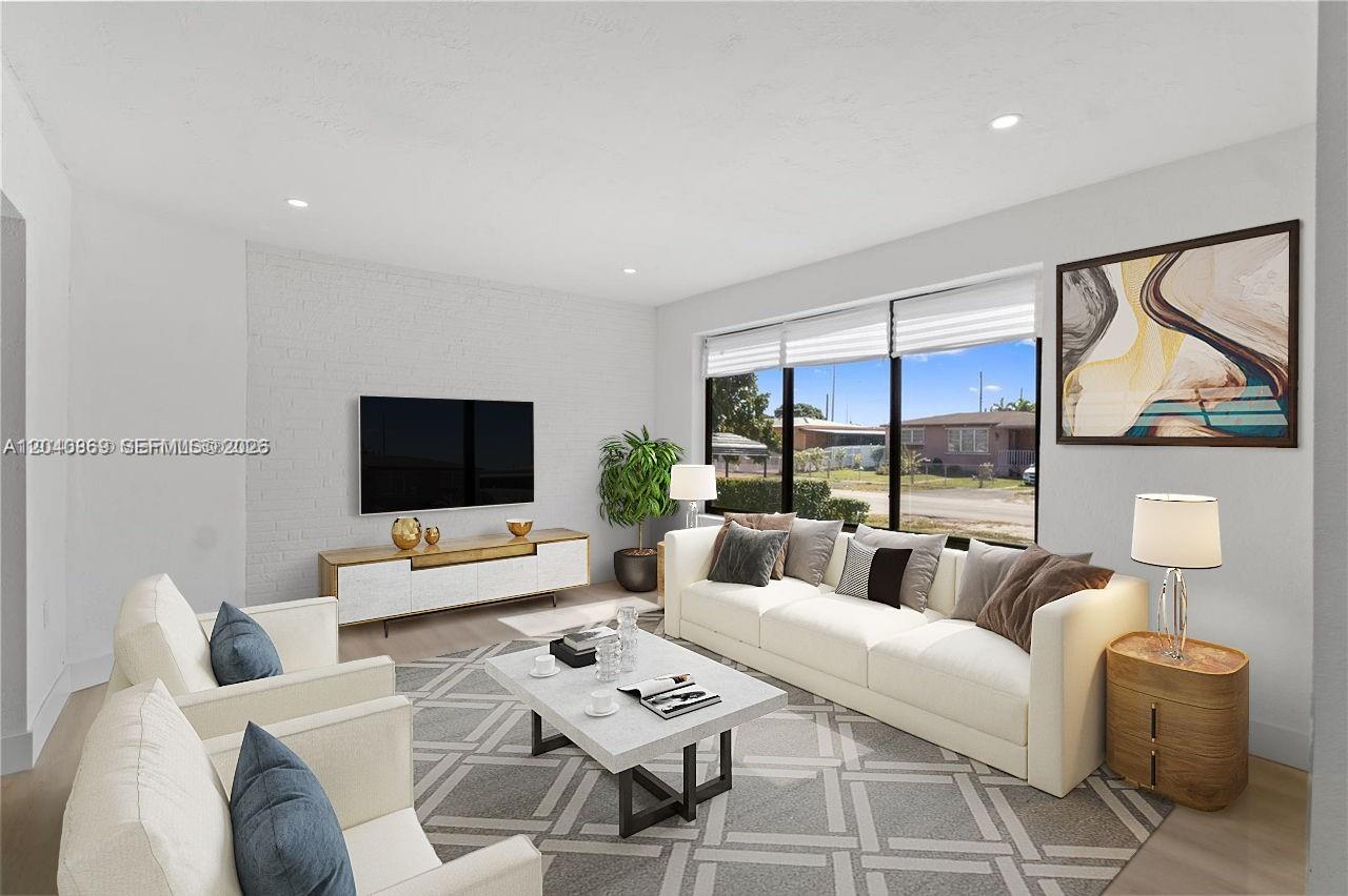 31 West 64th Street Hialeah, FL 33012 - Photo 6 of 49 a living room with furniture a flat screen tv and a large window