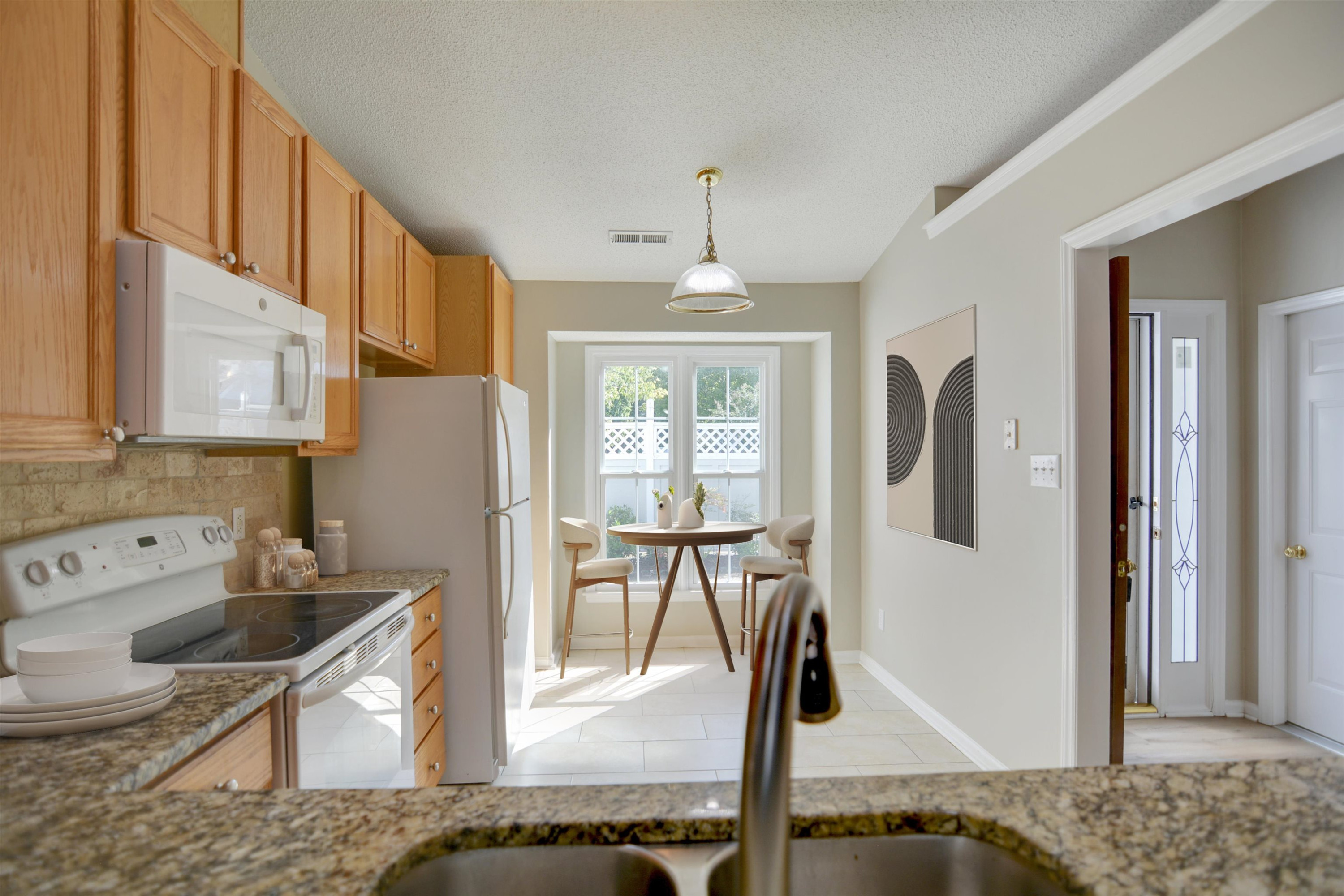 114 Breakers Place Cary, NC 27511 - Photo 11 of 19 a view of a kitchen with kitchen island granite countertop living room