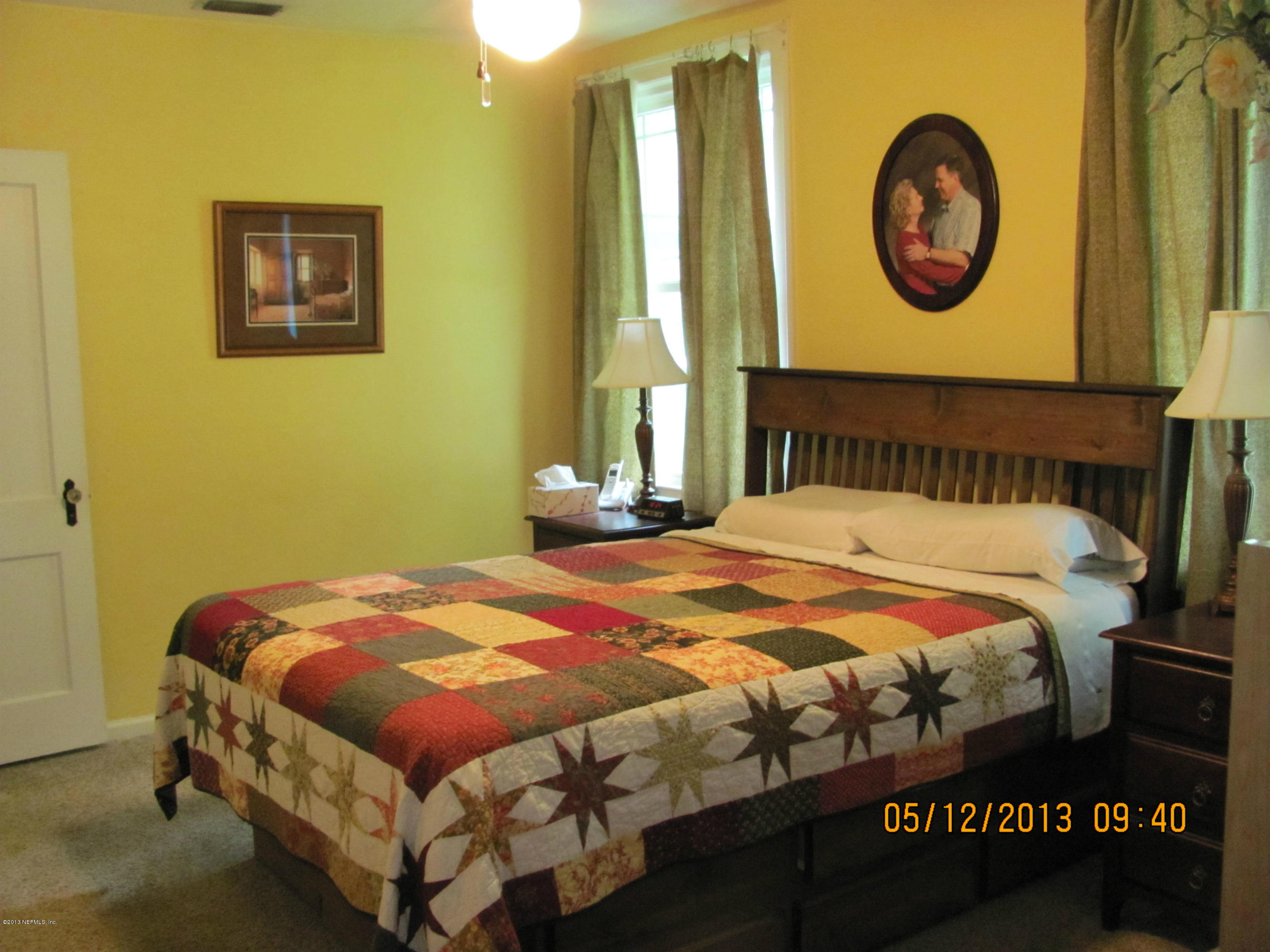 2121 Southampton Road Jacksonville, FL 32207 - Photo 12 of 21 a bedroom with a bed and a lamp next to a window