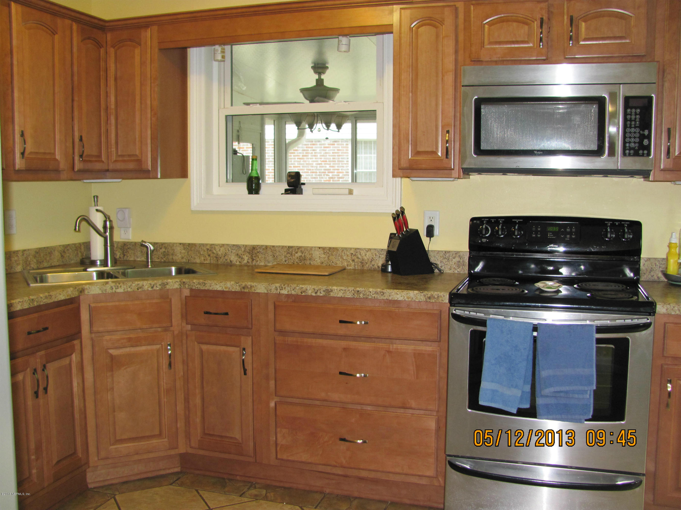 2121 Southampton Road Jacksonville, FL 32207 - Photo 17 of 21 a kitchen with granite countertop a stove and a sink