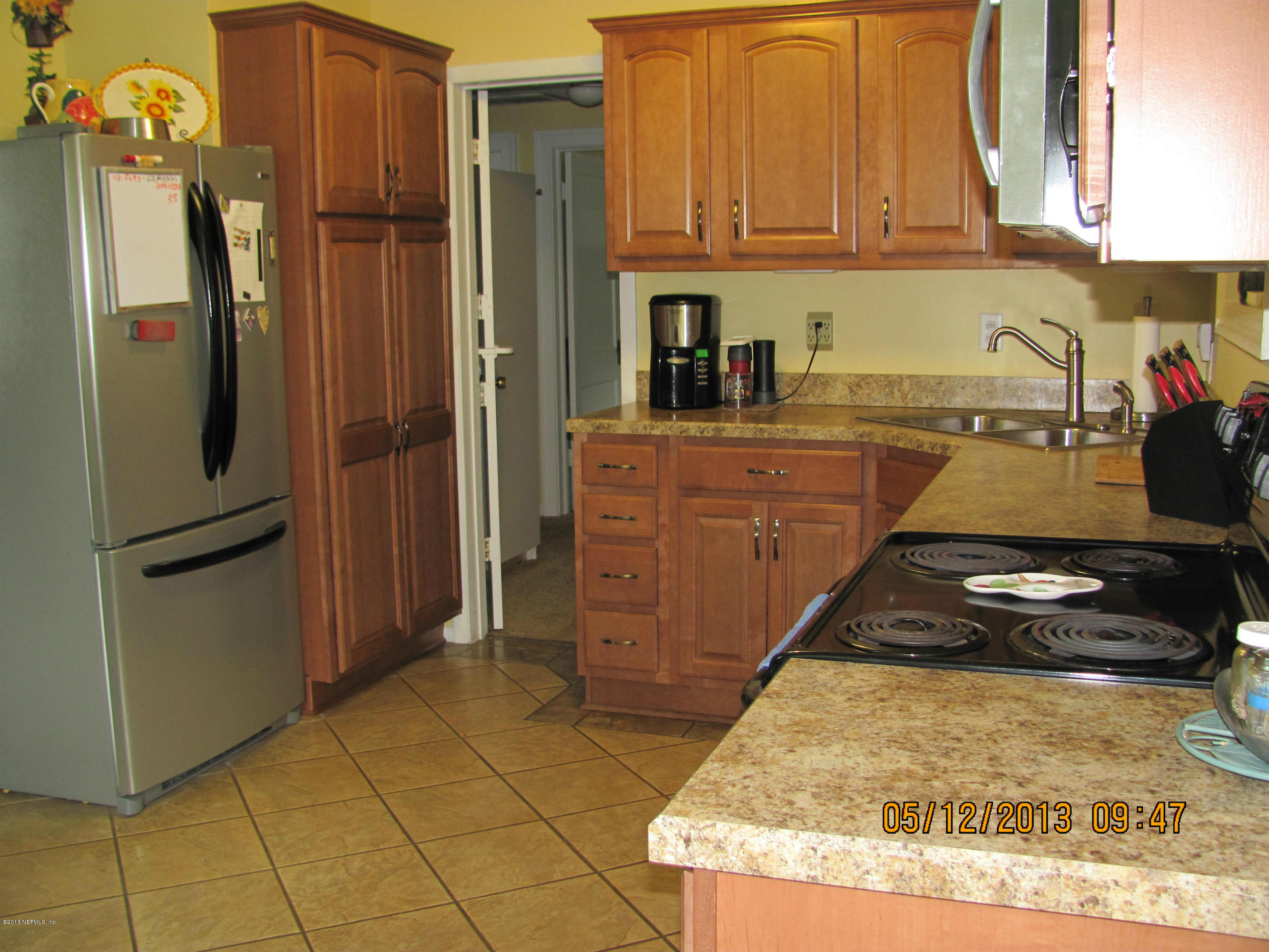 2121 Southampton Road Jacksonville, FL 32207 - Photo 18 of 21 a kitchen with kitchen island granite countertop a refrigerator a stove and a sink