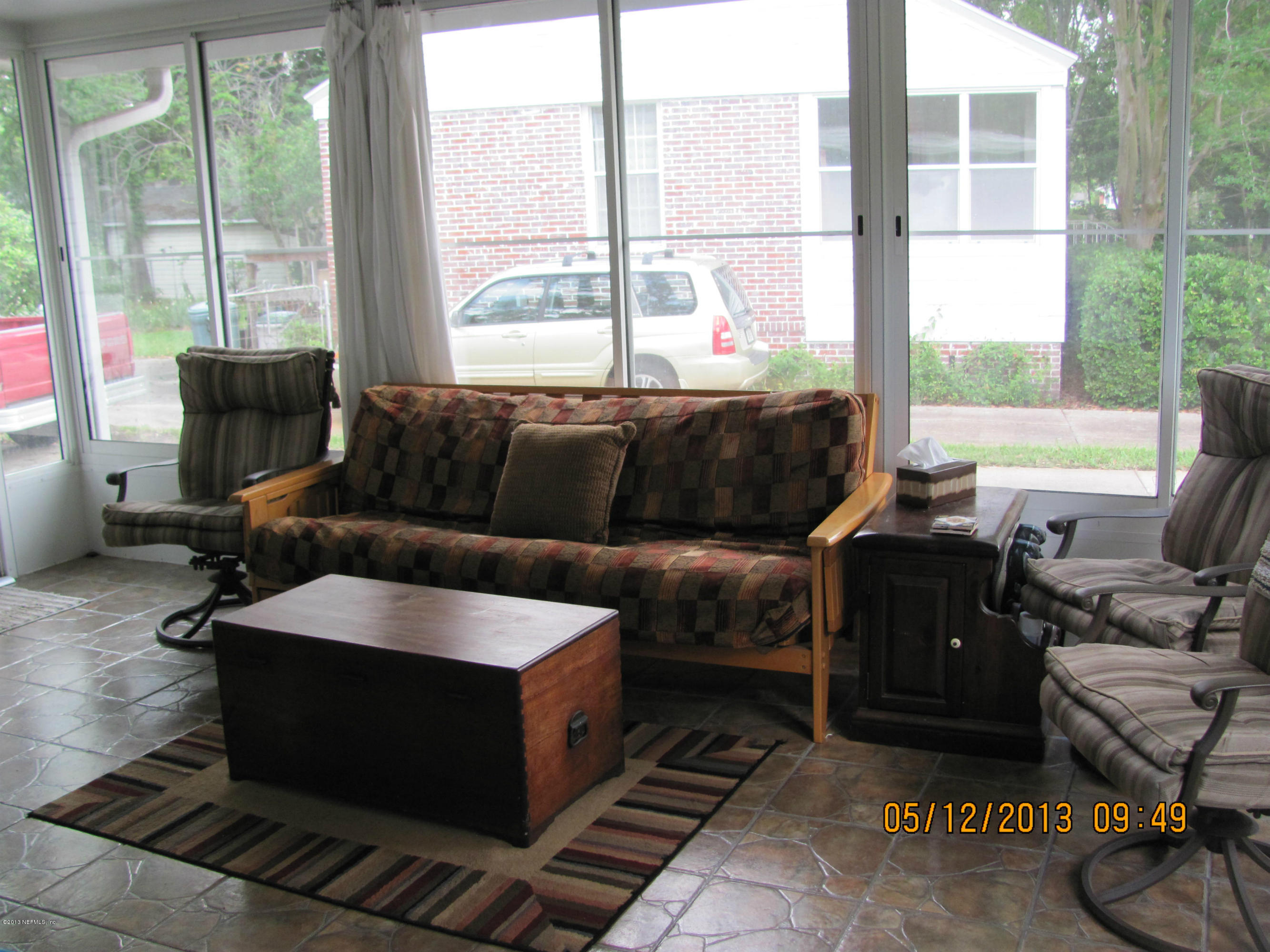 2121 Southampton Road Jacksonville, FL 32207 - Photo 20 of 21 a living room with furniture and a floor to ceiling window