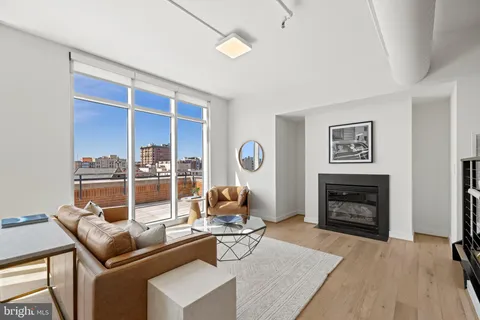 a living room with furniture a fireplace and a table