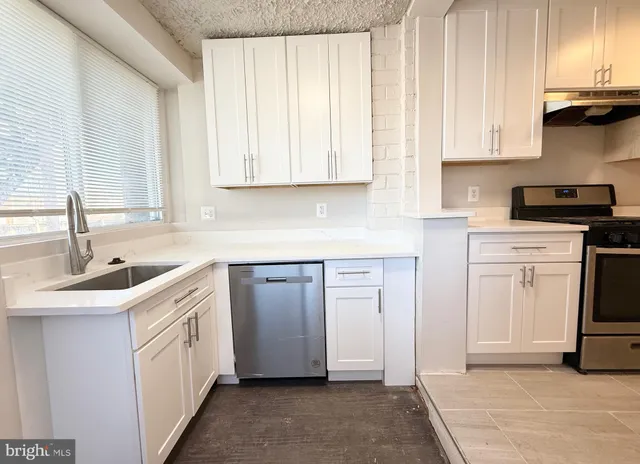 a kitchen with appliances cabinets and a sink