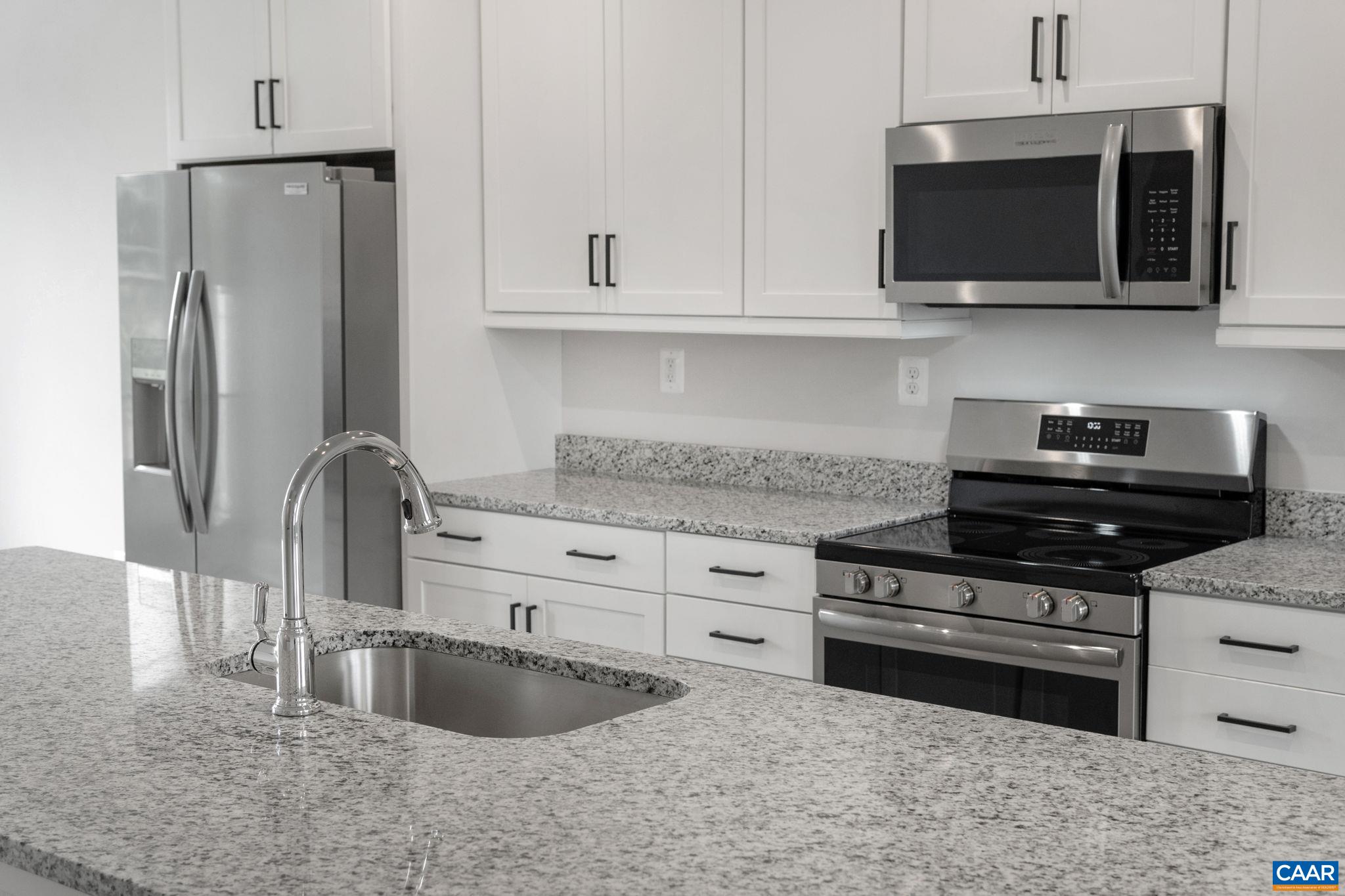 135 Park Ridge Drive Crozet, VA 22932 - Photo 11 of 46 a kitchen with stainless steel appliances granite countertop a stove a refrigerator and a microwave