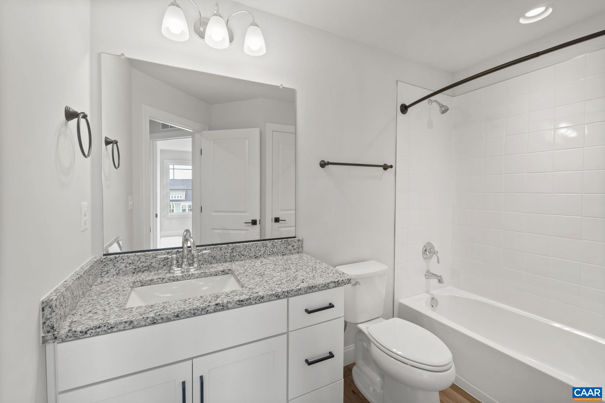 135 Park Ridge Drive Crozet, VA 22932 - Photo 33 of 46 a bathroom with a granite countertop sink a toilet and shower