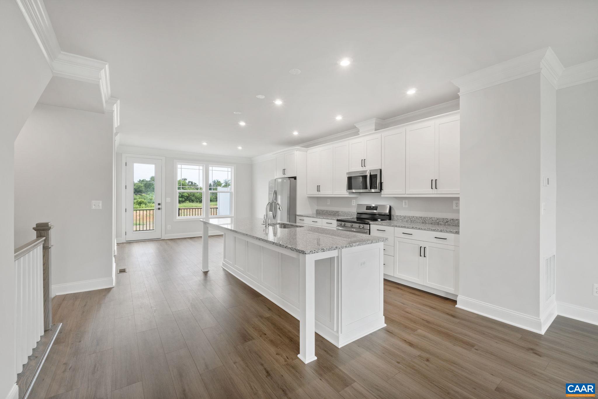 135 Park Ridge Drive Crozet, VA 22932 - Photo 10 of 46 a kitchen with stainless steel appliances granite countertop a stove top oven a sink a refrigerator white cabinets and wooden floor