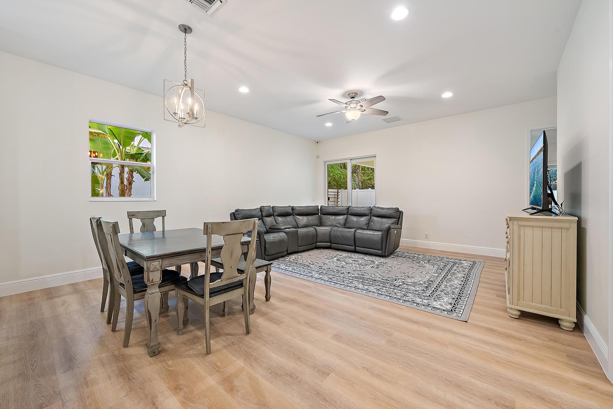 6762 2nd Street Jupiter, FL 33458 - Photo 11 of 27 a living room with furniture a chandelier and a dining table