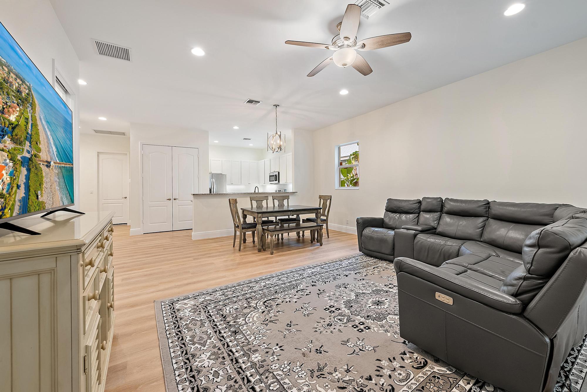6762 2nd Street Jupiter, FL 33458 - Photo 13 of 27 a living room with furniture and a flat screen tv