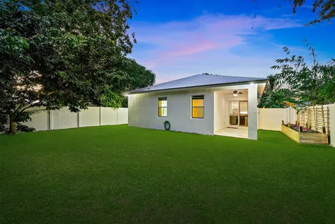a view of a backyard with a large tree