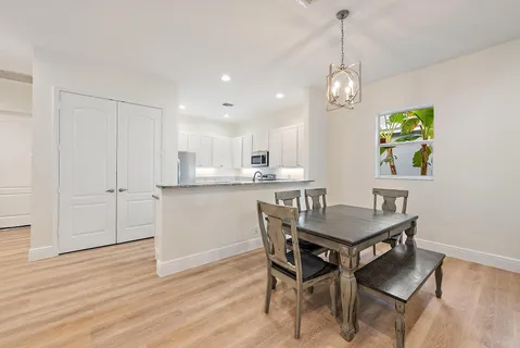 a view of a dining room with furniture and wooden floor