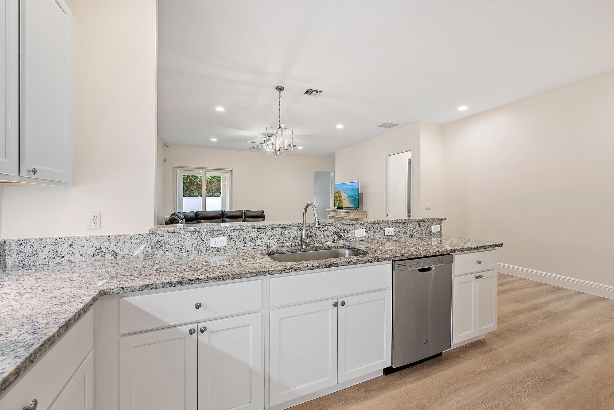 6762 2nd Street Jupiter, FL 33458 - Photo 9 of 27 a kitchen with a sink and cabinets