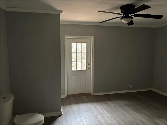 a view of a room with a hardwood and a window