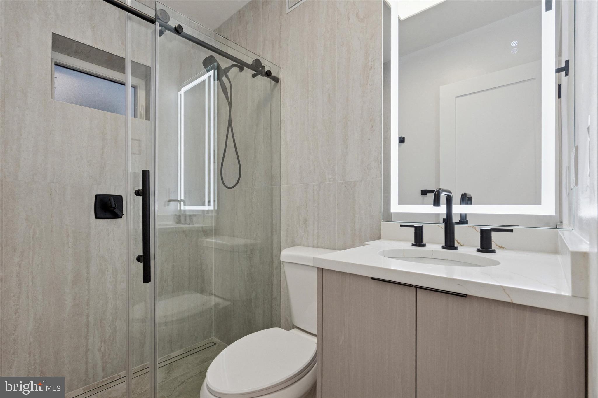 1438 Tasker Street, Unit 1 Philadelphia, PA 19145 - Photo 12 of 16 a bathroom with a sink toilet and shower