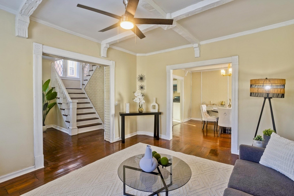 a living room with furniture and wooden floor