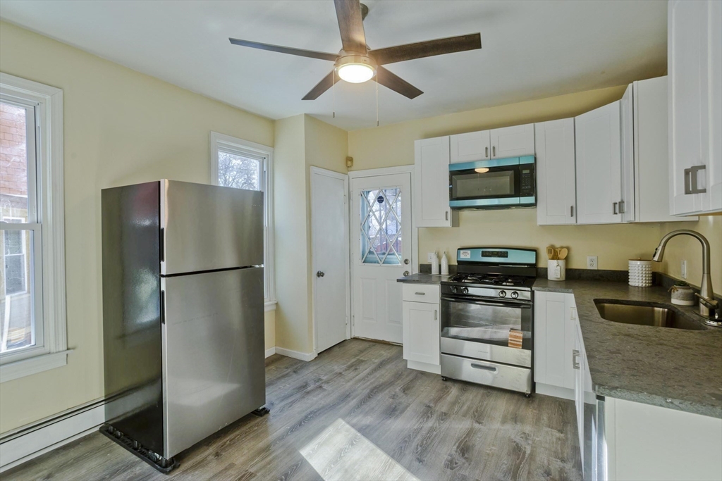 30 Parkwood Street Springfield, MA 01108 - Photo 18 of 41 a kitchen with stainless steel appliances a refrigerator stove and sink