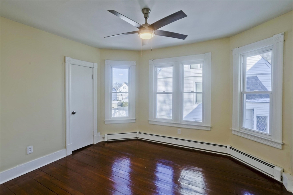 30 Parkwood Street Springfield, MA 01108 - Photo 22 of 41 a view of an empty room with wooden floor and a window