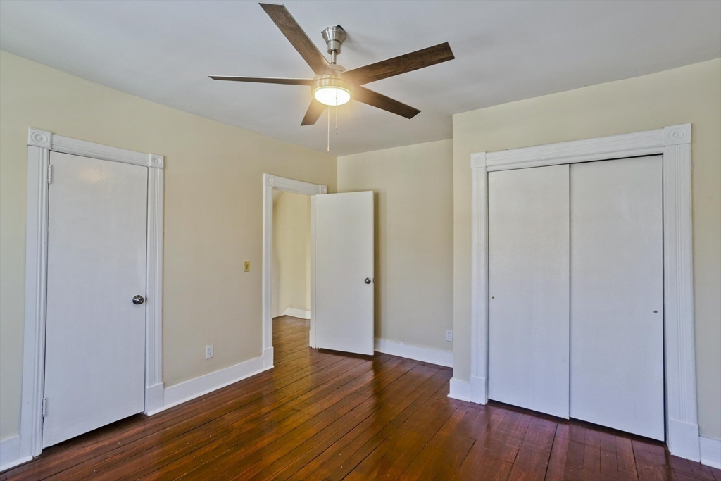 30 Parkwood Street Springfield, MA 01108 - Photo 26 of 41 an empty room with wooden floor door and windows