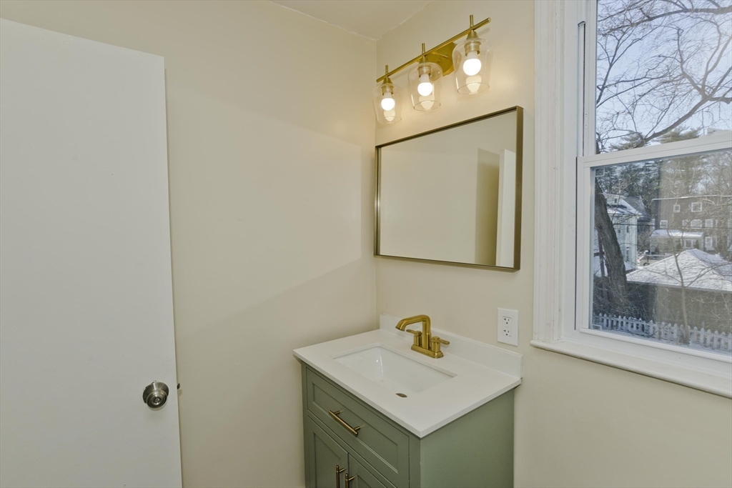 30 Parkwood Street Springfield, MA 01108 - Photo 33 of 41 a bathroom with a sink mirror and vanity