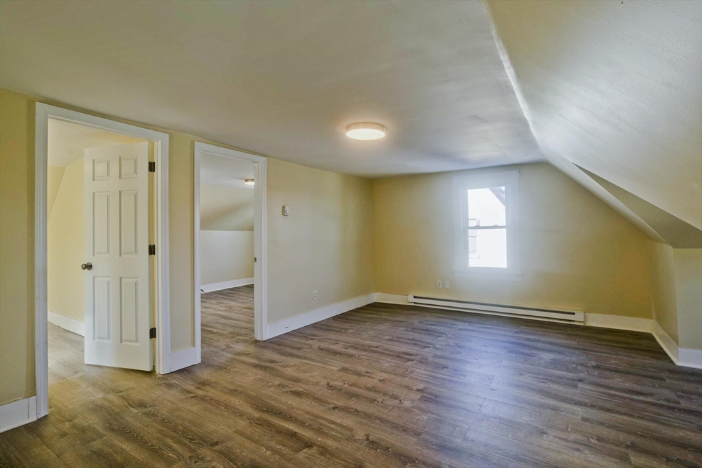 30 Parkwood Street Springfield, MA 01108 - Photo 34 of 41 a view of an empty room with wooden floor and a window