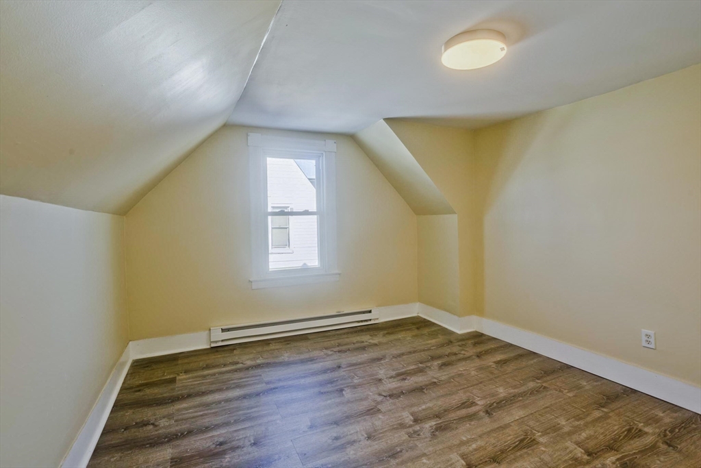 30 Parkwood Street Springfield, MA 01108 - Photo 37 of 41 an empty room with wooden floor and windows
