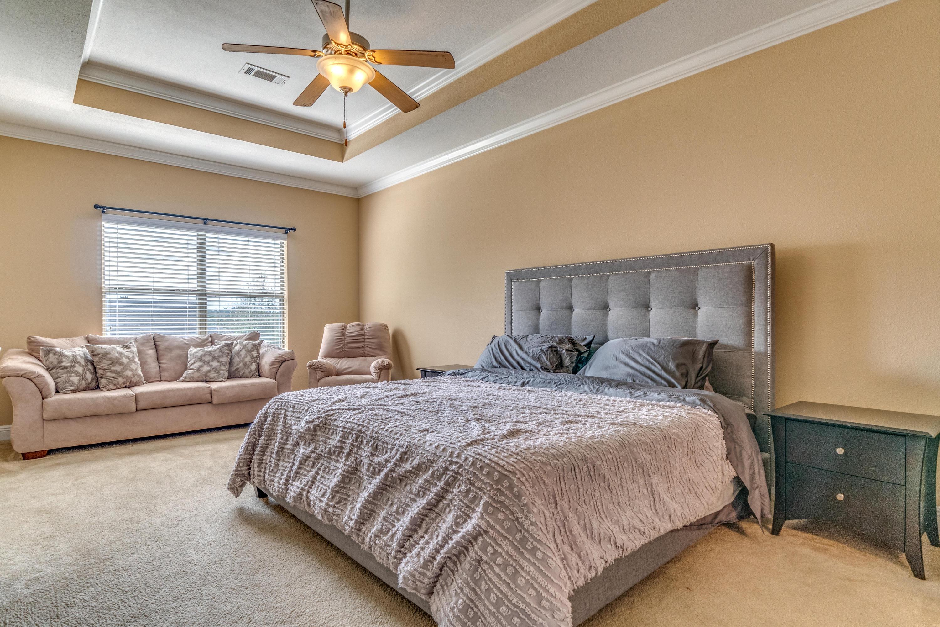 730 Lime Lane Crestview, FL 32536 - Photo 14 of 25 a spacious bedroom with a bed and a couch