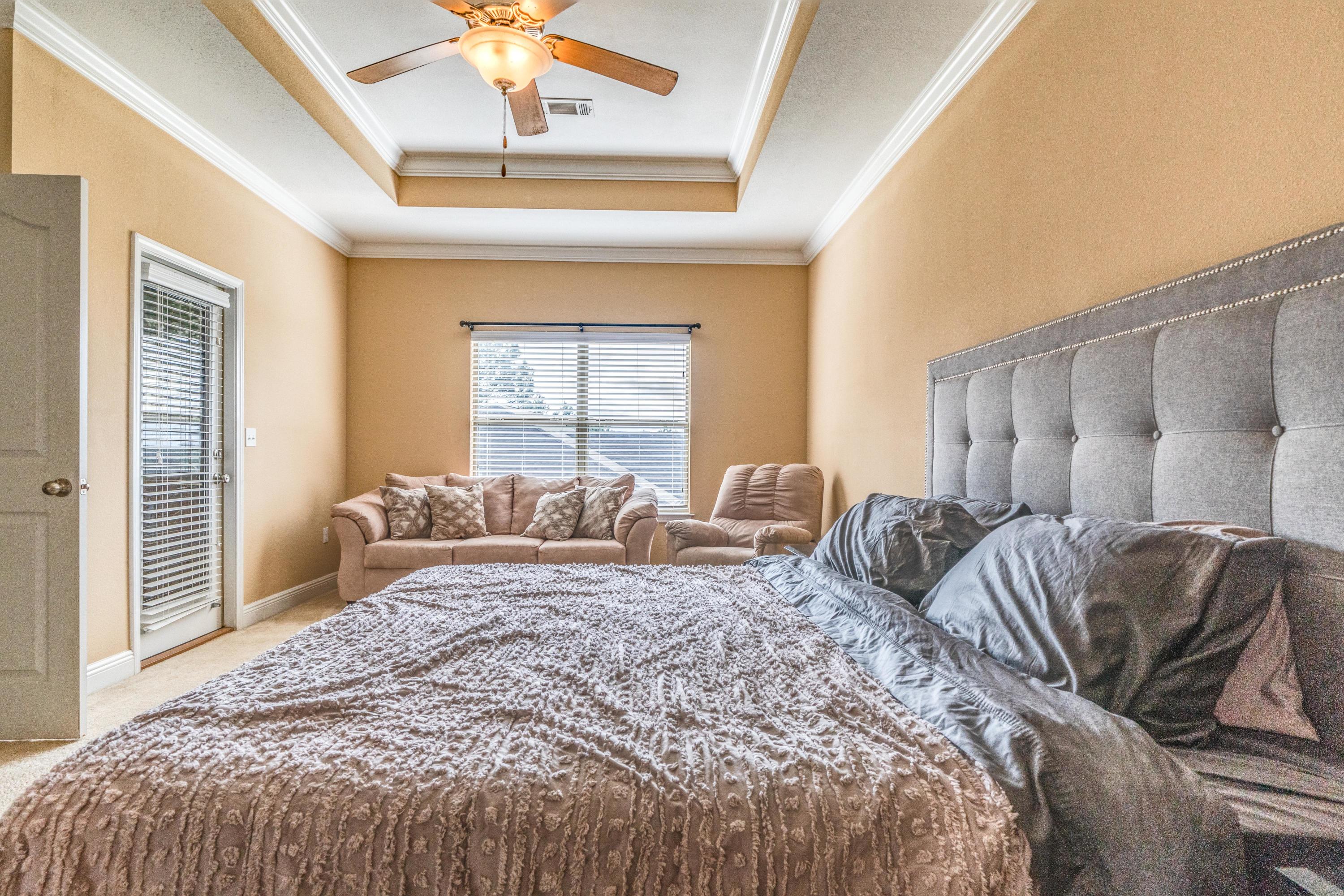 730 Lime Lane Crestview, FL 32536 - Photo 15 of 25 a bedroom with a large bed and a chandelier