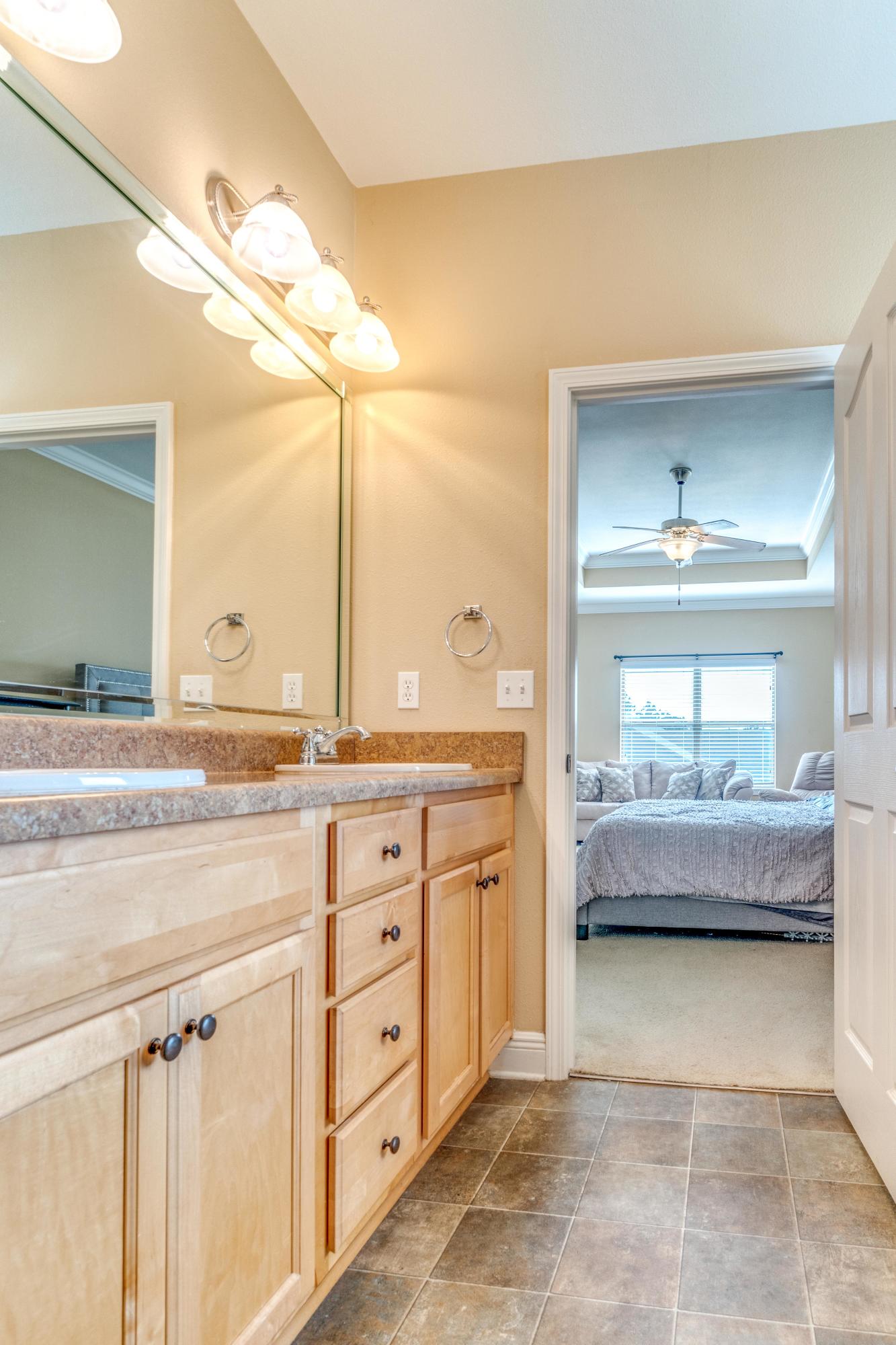 730 Lime Lane Crestview, FL 32536 - Photo 18 of 25 a en suite bathroom with a tub double vanity sink and mirror