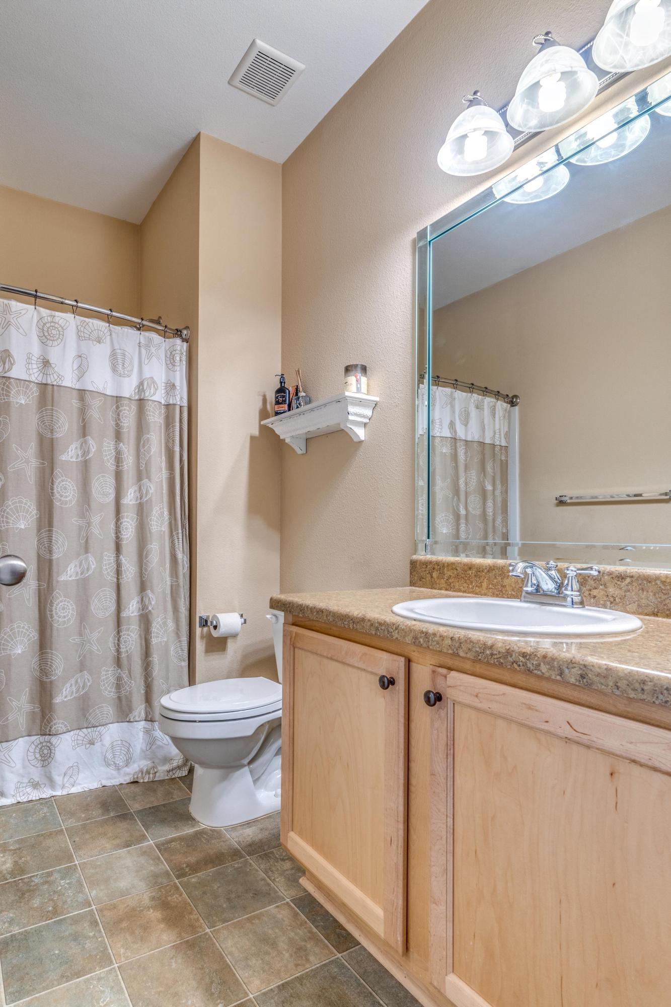 730 Lime Lane Crestview, FL 32536 - Photo 21 of 25 a bathroom with a granite countertop sink a toilet and a mirror