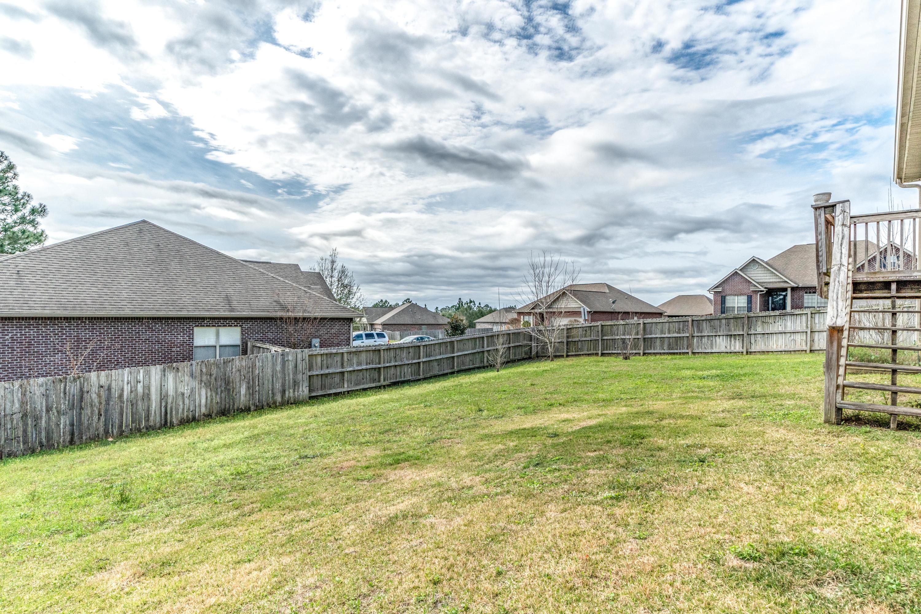 730 Lime Lane Crestview, FL 32536 - Photo 23 of 25 a view of an house with backyard and pool