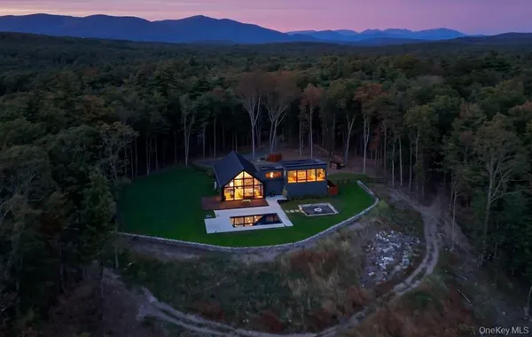 a view of a house with a yard and mountain view