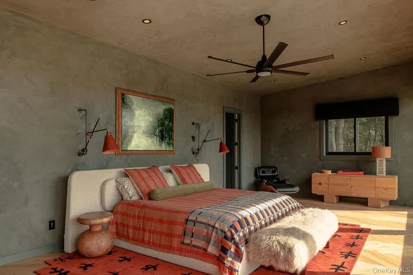 a bedroom with a bed couch and window