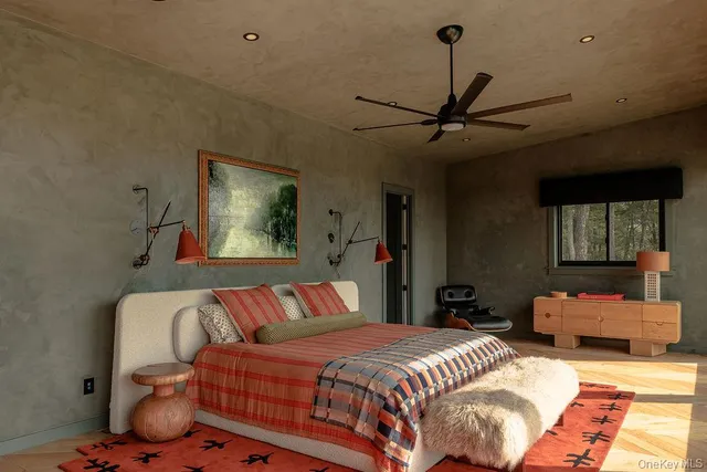 a bedroom with a bed couch and window