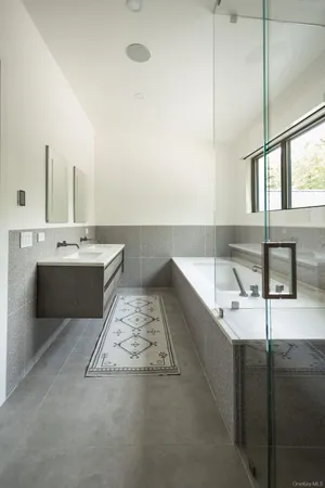 a bathroom with a bathtub and sink