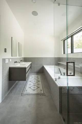a bathroom with a bathtub and sink