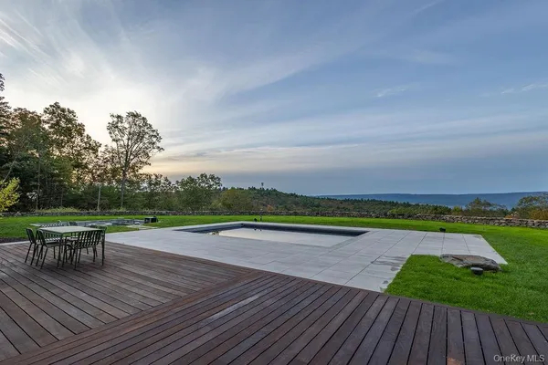 a view of a tiny house with yard and tree in the background