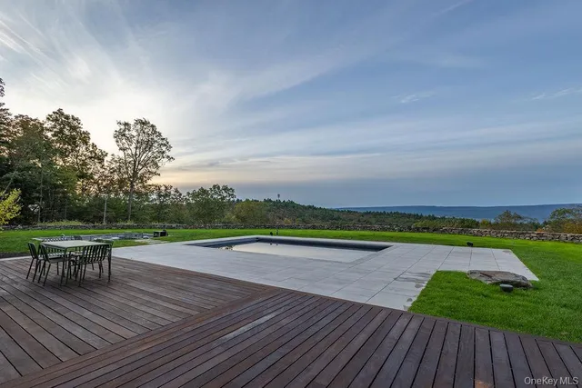 a view of a tiny house with yard and tree in the background