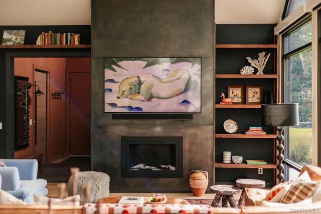 a living room with furniture and large windows